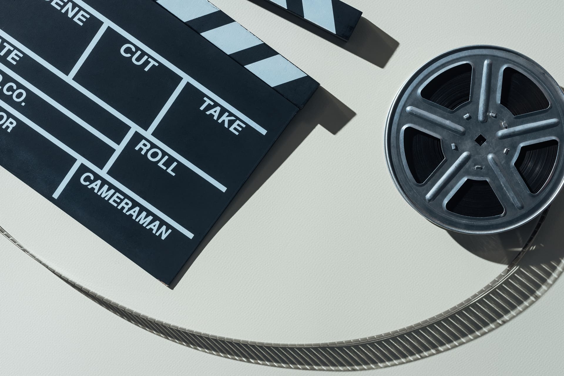 top-view-of-clapperboard-and-film-reel-with-cinema-2023-11-27-05-31-47-utc (1) (1) TV Film and Media